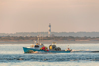 A fishing Boat Sunset Bodie Island Lighthouse